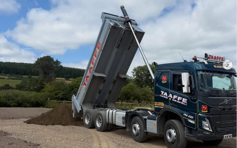 Topsoil being tipped from a Taaffe eight-wheel tipper