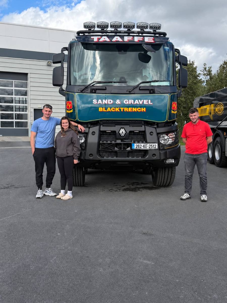 The Taaffe family standing in front of their Renault tipper