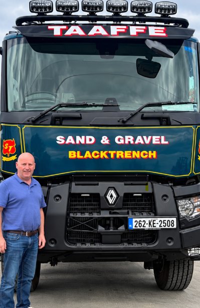 Sean Taaffe, owner of Taaffe Sand & Gravel, standing beside a Renault tipper